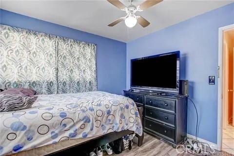 bedroom with hardwood / wood-style flooring and ceiling fan