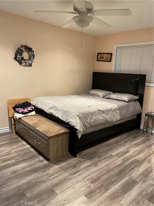 bedroom featuring wood-type flooring and ceiling fan