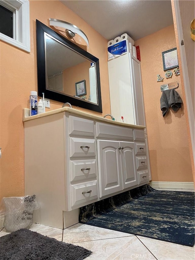 bathroom with tile patterned floors and vanity