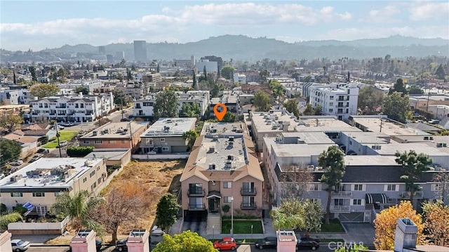 birds eye view of property with a mountain view