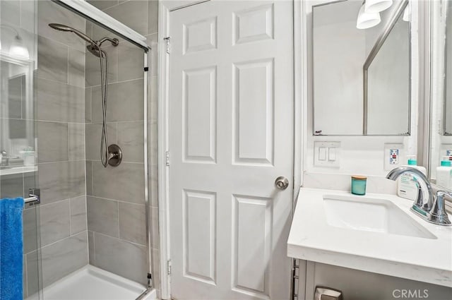 bathroom featuring vanity and a shower with door