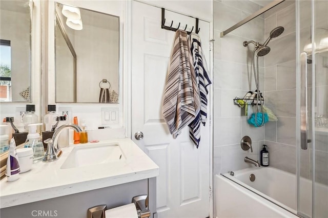 bathroom with tiled shower / bath combo and vanity