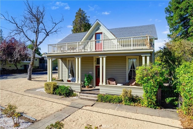 view of front of house featuring a balcony and a porch