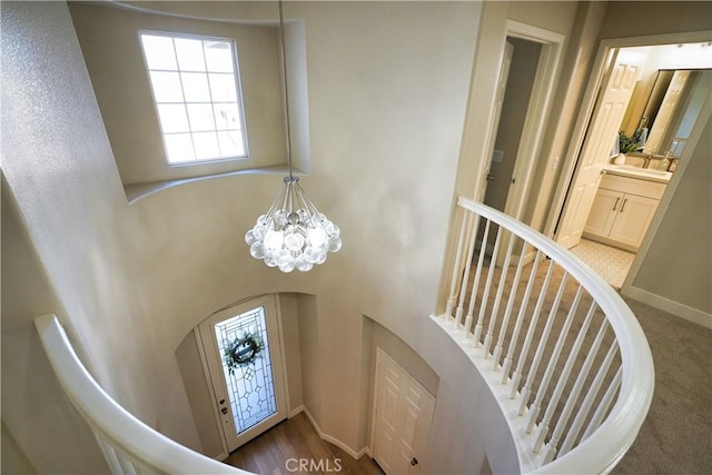 staircase featuring a chandelier