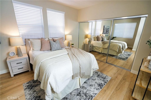 bedroom with light hardwood / wood-style flooring and a closet