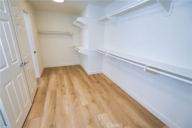 walk in closet featuring light hardwood / wood-style flooring