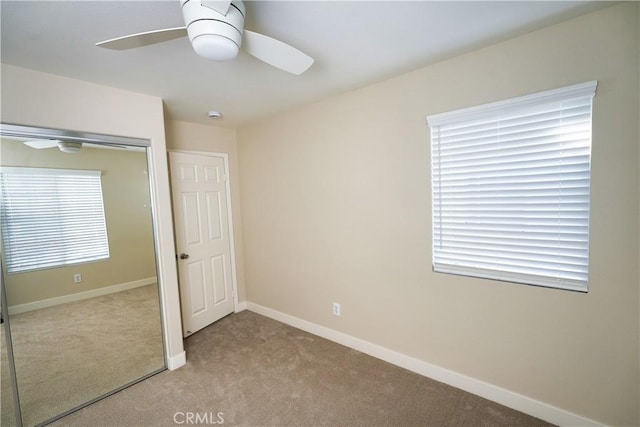 unfurnished bedroom featuring light colored carpet and ceiling fan