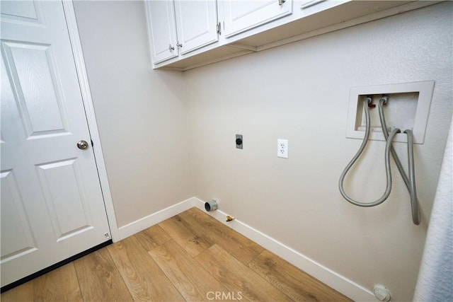 clothes washing area featuring gas dryer hookup, cabinets, light hardwood / wood-style flooring, hookup for a washing machine, and electric dryer hookup