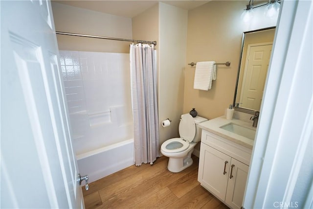 full bathroom with shower / bath combination with curtain, wood-type flooring, vanity, and toilet