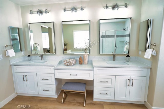 bathroom with vanity, an enclosed shower, and wood-type flooring