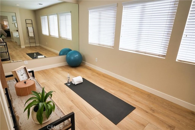 workout area with hardwood / wood-style floors