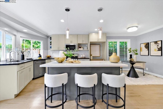 kitchen with pendant lighting, sink, appliances with stainless steel finishes, tasteful backsplash, and ornamental molding