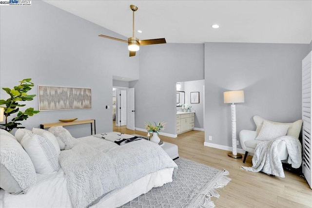 bedroom featuring ceiling fan, ensuite bath, lofted ceiling, and light hardwood / wood-style flooring