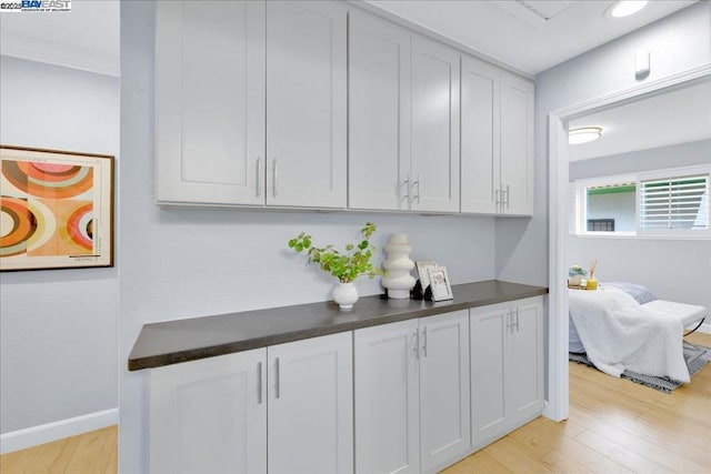 kitchen featuring white cabinetry and light wood-type flooring