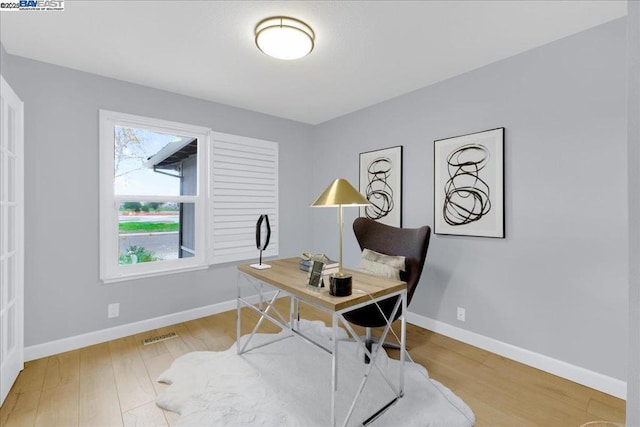 office space with wood-type flooring