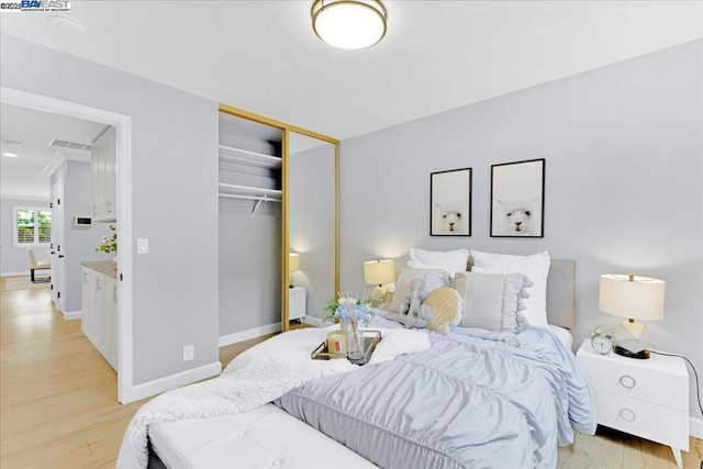 bedroom with a closet and light wood-type flooring