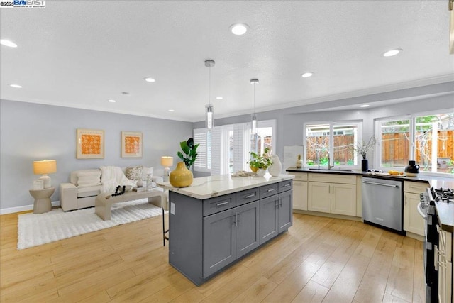 kitchen with gray cabinetry, light hardwood / wood-style flooring, pendant lighting, stainless steel appliances, and light stone countertops