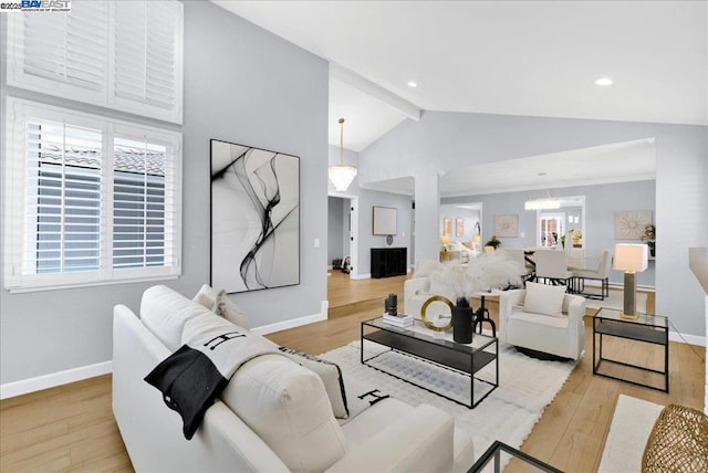 living room with high vaulted ceiling, beam ceiling, and light hardwood / wood-style floors