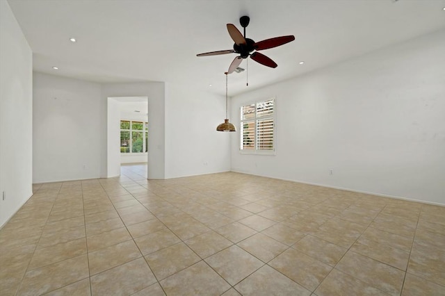 tiled empty room with ceiling fan