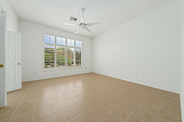 tiled empty room with ceiling fan