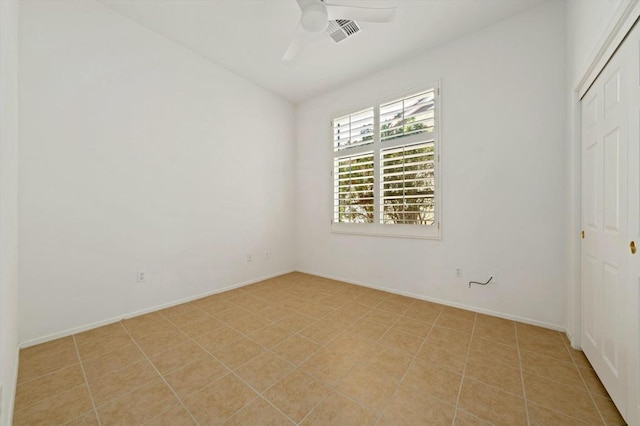 tiled empty room with ceiling fan