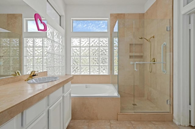 bathroom with tile patterned flooring, vanity, and independent shower and bath