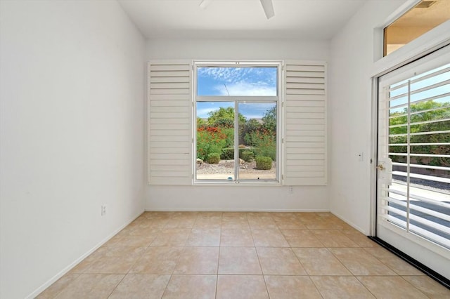 unfurnished room featuring light tile patterned floors and ceiling fan