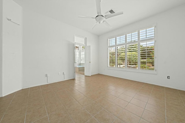 tiled empty room with ceiling fan