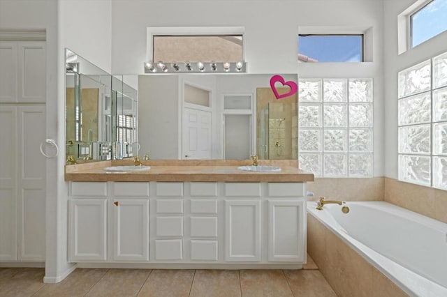 bathroom with tile patterned flooring, vanity, and independent shower and bath