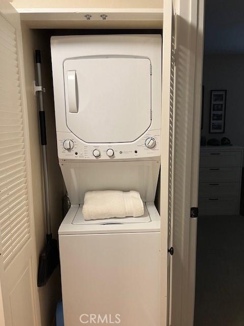 washroom with stacked washer and clothes dryer