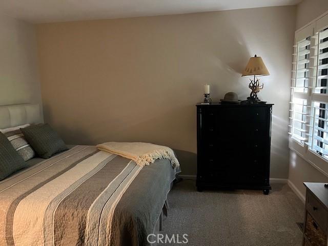 bedroom featuring dark carpet