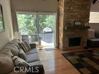 living room featuring hardwood / wood-style flooring and a fireplace