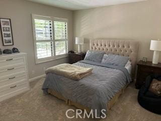 bedroom featuring light colored carpet