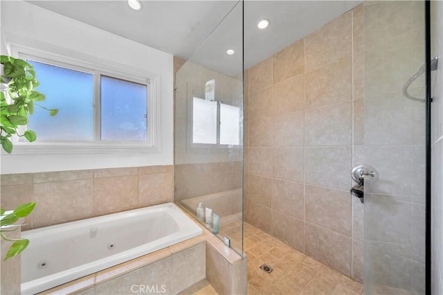 bathroom featuring separate shower and tub