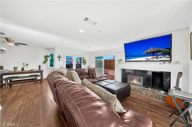 living room featuring ceiling fan and hardwood / wood-style floors