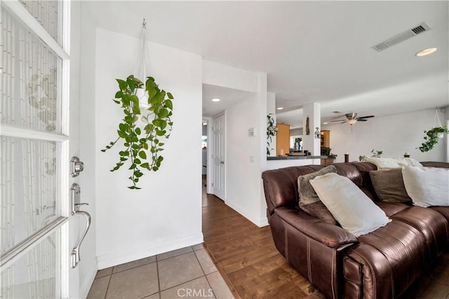 living room featuring tile patterned floors and ceiling fan