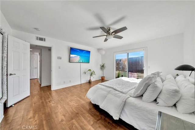 bedroom featuring hardwood / wood-style flooring, access to outside, and ceiling fan