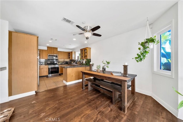 dining room with ceiling fan and light hardwood / wood-style flooring