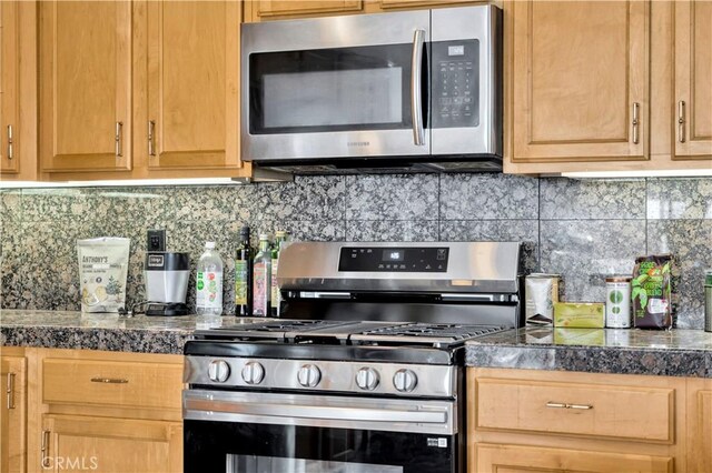 kitchen with backsplash and appliances with stainless steel finishes