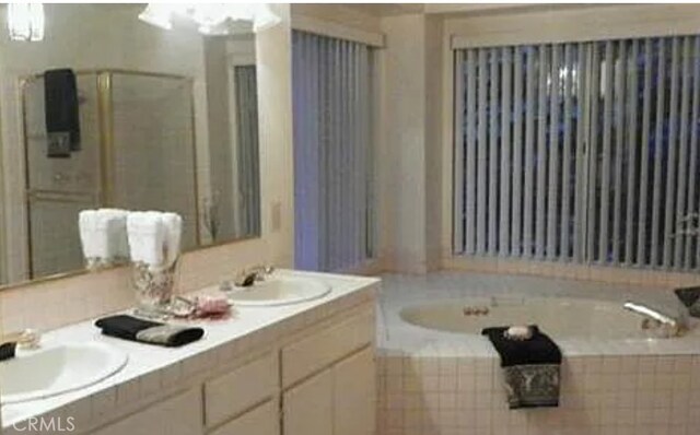 bathroom featuring vanity and plus walk in shower