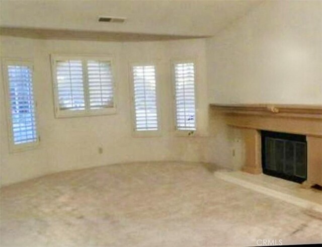 unfurnished living room featuring carpet floors