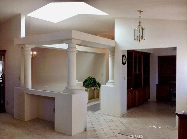 interior space with decorative columns and light tile patterned flooring