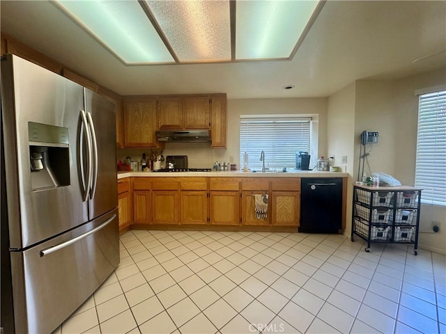 kitchen with light tile patterned flooring, sink, and black appliances