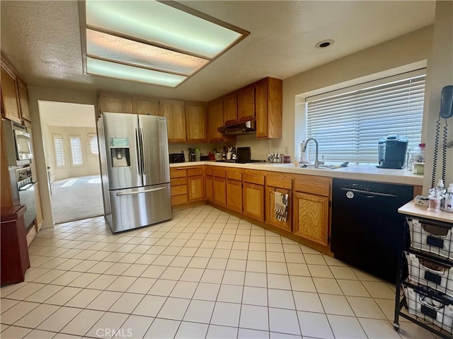 kitchen featuring sink, light tile patterned floors, a textured ceiling, and black appliances