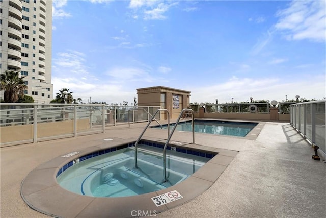 view of swimming pool with a patio area and a community hot tub