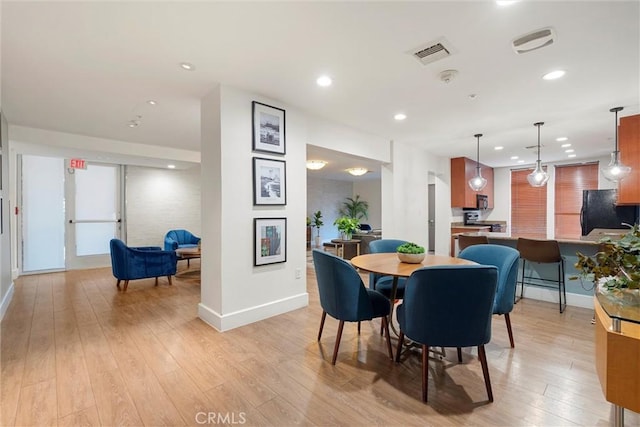 dining area with light wood-type flooring