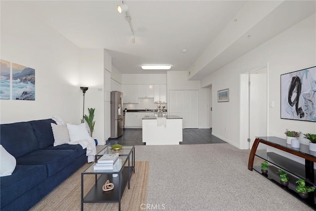 carpeted living room with track lighting