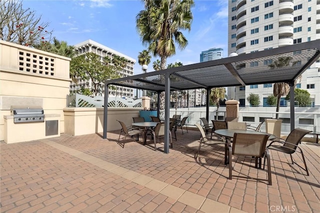 view of patio / terrace with exterior kitchen, grilling area, and a pergola