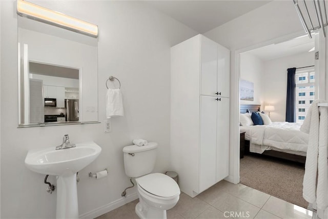 bathroom with tile patterned floors, toilet, and sink