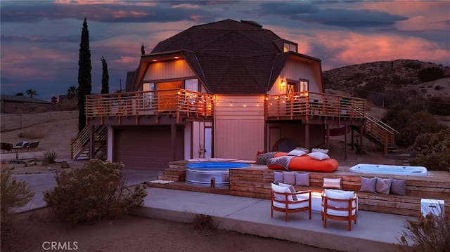 view of front of home featuring an outdoor hot tub, stairs, and a patio area